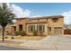 Charming two-story home featuring a stone facade, two-car garage, and well-maintained landscaping at 20916 E Via De Arboles --, Queen Creek, AZ 85142
