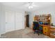 Home office featuring wall-to-wall carpet, ceiling fan, closet, and desk at 20916 E Via De Arboles --, Queen Creek, AZ 85142