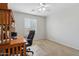 This room is carpeted with a window, ceiling fan, desk, and office chair at 20916 E Via De Arboles --, Queen Creek, AZ 85142