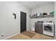Laundry room featuring new washer and dryer units and a shelf with cleaning supplies at 20916 E Via De Arboles --, Queen Creek, AZ 85142