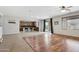 Open concept living area showcasing natural light, wood floors, and access to the backyard at 20916 E Via De Arboles --, Queen Creek, AZ 85142
