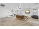 A modern, carpeted living room with ceiling fan, television, and workout machine at 20916 E Via De Arboles --, Queen Creek, AZ 85142