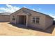 Back of home showing covered patio and large windows for natural light at 24598 W Grenadine Rd, Buckeye, AZ 85326