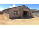 Back of home showing covered patio and large windows for natural light at 24598 W Grenadine Rd, Buckeye, AZ 85326