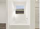 A modern bathroom featuring a tub and window for natural light at 24612 W Grenadine Rd, Buckeye, AZ 85326
