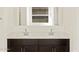 Modern bathroom featuring double sinks and a window at 24612 W Grenadine Rd, Buckeye, AZ 85326