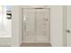 Modern bathroom featuring a glass-enclosed shower and neutral tones at 24612 W Grenadine Rd, Buckeye, AZ 85326