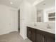 Modern bathroom featuring double sinks, espresso cabinets, and a tiled floor at 24612 W Grenadine Rd, Buckeye, AZ 85326