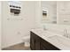 Bathroom features double sinks, dark cabinets, and an elongated toilet at 24612 W Grenadine Rd, Buckeye, AZ 85326