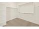 Walk-in closet with carpet floors and shelving units at 24612 W Grenadine Rd, Buckeye, AZ 85326
