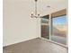 Bright dining area with neutral walls, tiled flooring, and sliding glass doors that allow for lots of natural light at 24612 W Grenadine Rd, Buckeye, AZ 85326