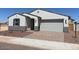 Inviting single-story home featuring a neutral color palette, a two-car garage, and desert landscaping at 24612 W Grenadine Rd, Buckeye, AZ 85326
