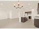Open floor plan with a modern kitchen, center island, and a seamless transition into a bright and airy living space at 24612 W Grenadine Rd, Buckeye, AZ 85326