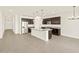 Open concept kitchen with stainless steel appliances, granite countertops and large center island at 24612 W Grenadine Rd, Buckeye, AZ 85326