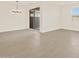 Open concept living room with tile flooring, chandelier and access to backyard at 24612 W Grenadine Rd, Buckeye, AZ 85326