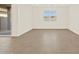 Bright, spacious living room with tile flooring and window at 24612 W Grenadine Rd, Buckeye, AZ 85326