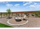 Beautiful backyard with a custom fire pit and comfortable seating at 26947 W Adam Ave, Buckeye, AZ 85396