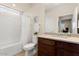 Bright bathroom featuring a shower-tub combo, a granite vanity and a large mirror at 26947 W Adam Ave, Buckeye, AZ 85396