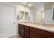 Bathroom vanity with double sinks and granite countertop plus large mirror at 26947 W Adam Ave, Buckeye, AZ 85396
