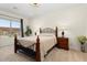 Cozy bedroom features a wrought iron bed frame, neutral tones, and ample natural light at 26947 W Adam Ave, Buckeye, AZ 85396