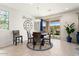 Cozy dining area with neutral tile floors, a modern chandelier, and sliding door access to the patio at 26947 W Adam Ave, Buckeye, AZ 85396