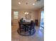Formal dining area showcasing a round table with pendant lighting and large windows with views at 26947 W Adam Ave, Buckeye, AZ 85396