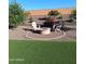 Beautifully landscaped backyard with a charming fire pit surrounded by comfortable seating at 26947 W Adam Ave, Buckeye, AZ 85396