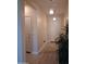Hallway boasts pendant lighting, neutral walls, and tile flooring at 26947 W Adam Ave, Buckeye, AZ 85396