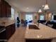 Open kitchen featuring granite countertops, stainless appliances, and a view into the living area at 26947 W Adam Ave, Buckeye, AZ 85396