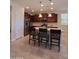 Modern kitchen with an island, stainless steel appliances, and ample counter space with a bar stool seating arrangement at 26947 W Adam Ave, Buckeye, AZ 85396