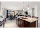 Spacious kitchen island with sink, seating, stainless appliances, and open layout to living areas at 26947 W Adam Ave, Buckeye, AZ 85396