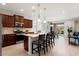 An open kitchen design with an island, modern appliances, and seamless flow to outdoor dining area at 26947 W Adam Ave, Buckeye, AZ 85396