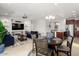 Spacious living room features a dining area, kitchen, and built-in media center with modern tile flooring at 26947 W Adam Ave, Buckeye, AZ 85396