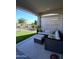 Inviting covered patio featuring comfortable seating, stylish decor, and view of landscaped backyard at 26947 W Adam Ave, Buckeye, AZ 85396
