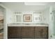 Bathroom vanity with dual sinks, framed mirrors, and a neutral countertop at 3140 E Claremont Ave, Phoenix, AZ 85016