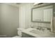 Modern bathroom featuring a marble countertop, gray vanity, and contemporary finishes at 3140 E Claremont Ave, Phoenix, AZ 85016