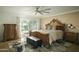 Spacious primary bedroom featuring a king bed, elegant furnishings, and access to outdoor patio at 3140 E Claremont Ave, Phoenix, AZ 85016
