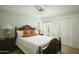 Comfortable bedroom with a dark wood bed frame, side tables, and lots of natural light at 3140 E Claremont Ave, Phoenix, AZ 85016