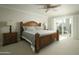 Well-lit bedroom showcasing a large, ornate wood bed frame and sliding door access to the outside at 3140 E Claremont Ave, Phoenix, AZ 85016