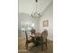 Dining room with a modern light fixture, shuttered windows, and an inlaid dining table at 3140 E Claremont Ave, Phoenix, AZ 85016