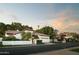 Charming single-story home with a red tile roof, well-manicured landscaping, and a two-car garage at 3140 E Claremont Ave, Phoenix, AZ 85016