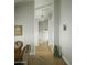 Bright hallway featuring hardwood floors and crisp white trim, leading to other rooms at 3140 E Claremont Ave, Phoenix, AZ 85016