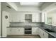 Updated kitchen with white cabinets, stainless steel appliances, and stylish backsplash at 3140 E Claremont Ave, Phoenix, AZ 85016