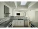 Bright, modern kitchen with stainless steel appliances and views into the adjoining living space at 3140 E Claremont Ave, Phoenix, AZ 85016
