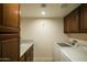 Well-equipped laundry room with a sink, upper cabinets, and modern washer and dryer at 3140 E Claremont Ave, Phoenix, AZ 85016