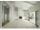 Open living area with a stone fireplace, built-in shelving, and vaulted ceilings at 3140 E Claremont Ave, Phoenix, AZ 85016