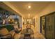 Covered patio featuring comfortable seating, travertine flooring, and views of the lush backyard at 3140 E Claremont Ave, Phoenix, AZ 85016