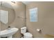 A simple half-bathroom featuring a pedestal sink, toilet, and window at 3360 E Joseph Way, Gilbert, AZ 85295