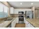 Charming kitchen featuring granite countertops, stainless steel appliances, and white cabinets at 3360 E Joseph Way, Gilbert, AZ 85295