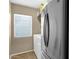 A functional laundry room with washer, dryer, and a stainless steel refrigerator at 3360 E Joseph Way, Gilbert, AZ 85295
